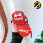 Red cola-style AirPods Pro silicone case with metal carabiner on white background