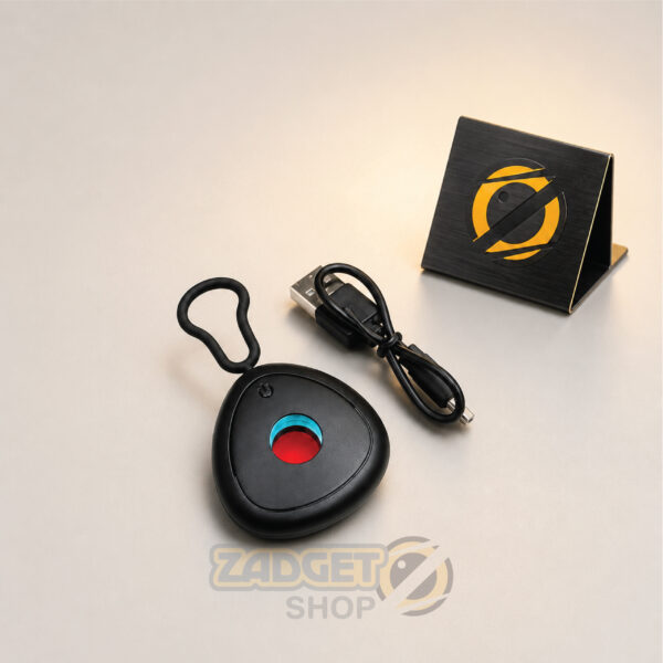 Black mini hidden camera detector with lens filter, carrying loop and USB charging cable