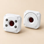Two views of white Mini Hidden Camera Detector showing four LED lights and optical lens checking design
